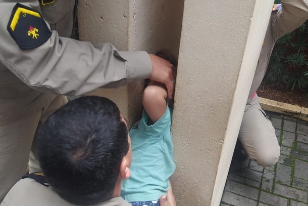 Menino fica preso em colunas de concreto
